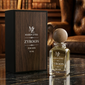 Maison Zyra Zyroon perfume bottle and wooden box on a marble surface with books and a leather chair in the background.